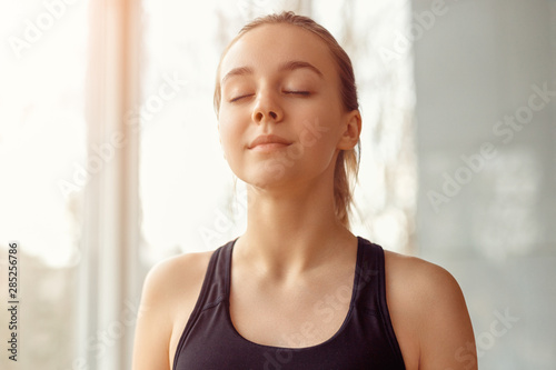 Sporty woman meditating with closed eyes © kegfire