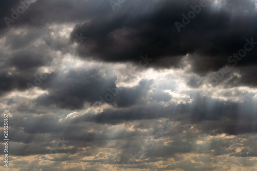 Dramatic sky panorama with sun rays between clouds. Idyllic sun beams cloudscape backdrop. Majestic cloud scenery