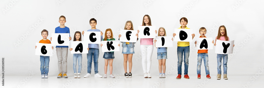 Black friday, sales concept. Group of childrens, kids and teens in