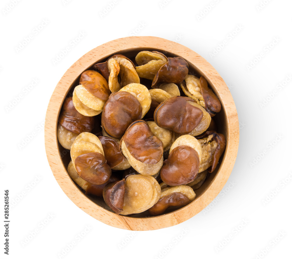 Broad windsor fava bean seeds in wood bowl isolated on white background. top view