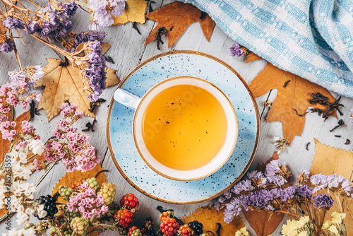 Konstfotografi autumn warming tea on a wooden table with autumn tree leaves lying nearby