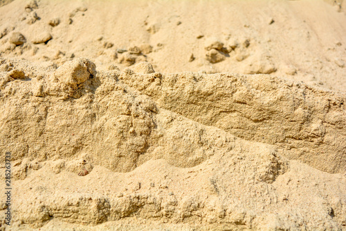 Pile of yellow sand texture. Construction Supplies. Sand pile with small stones
