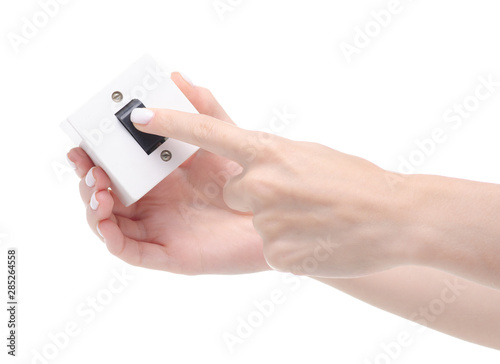 Plastic switch button in hand on a white background isolation