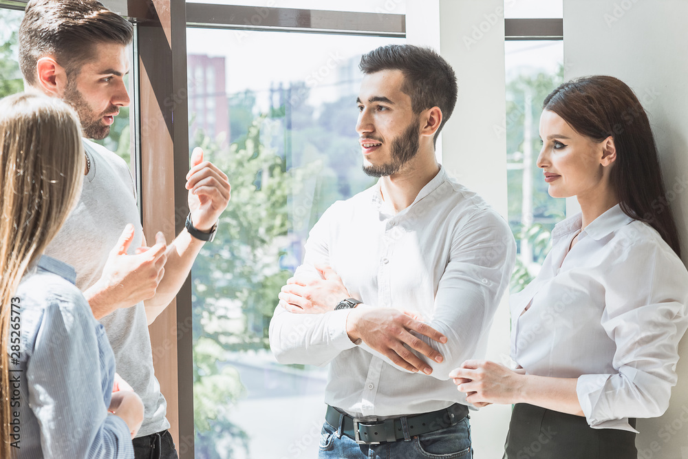 Young students discuss the topic of a lecture in between classes