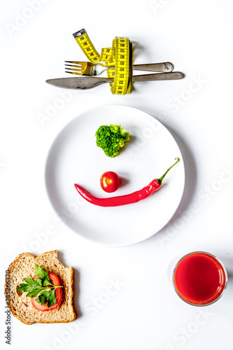concept slimming diet fresh vegetables on white background top view