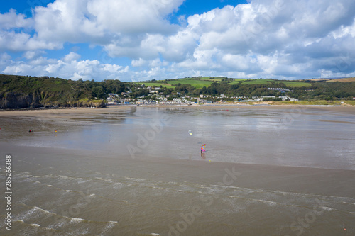 Aerial view of person kite surfing on the water of pendine sands beach wales uk