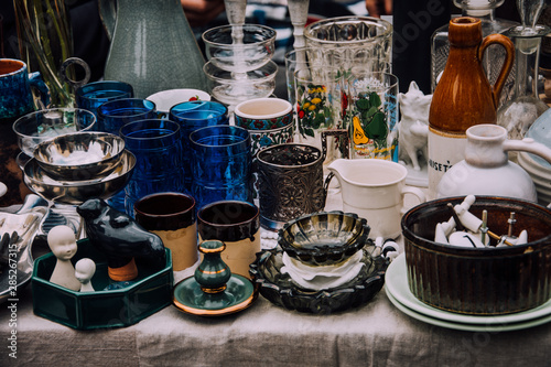 flea market. Vintage stuff. Aesthetics. Fair of old things. Sale of unnecessary things. Garage sale. Weekend Market. Dishes, souvenirs, teapot, cups, spoons, figurines. Antiques. Second hand