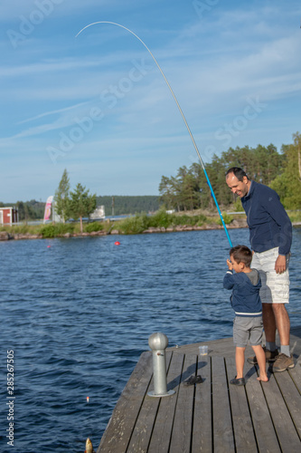 Boy fishing with his father