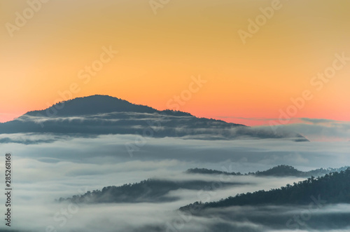 Fog and complex of mountain landscape with colorful twilight. © Patiwat