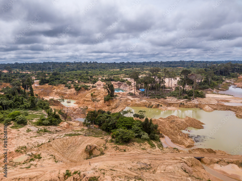 Aerial view of deforested area of the Amazon rainforest caused by illegal mining activities in Brazil. Deforestation and illegal gold mining destroy the forest and contaminate the rivers with mercury.