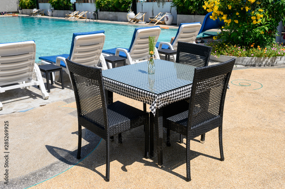 Table and chairs with swimming pool
