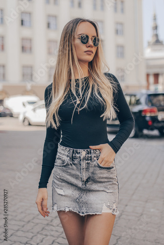 Beautiful young woman posing in the street, wearing sunglasses. Fashion summer photo. photo