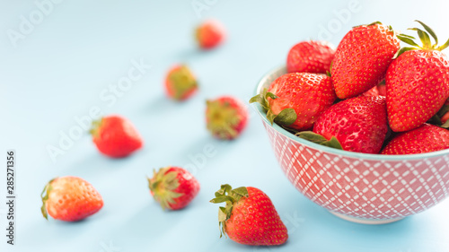 fresh Strawberry in a bowl top view on blue background