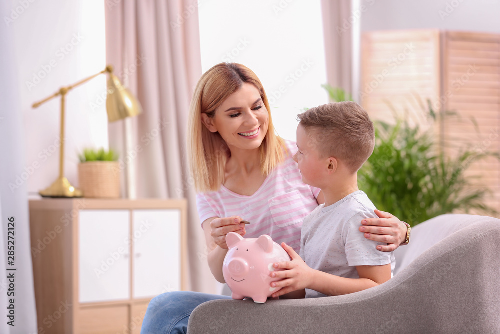Family with piggy bank and money at home. Space for text Family with piggy bank and money at home. Space for text