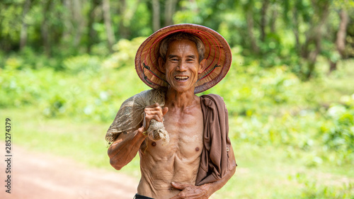 Portrait of happy farmer in rice field at countryside Thailand.