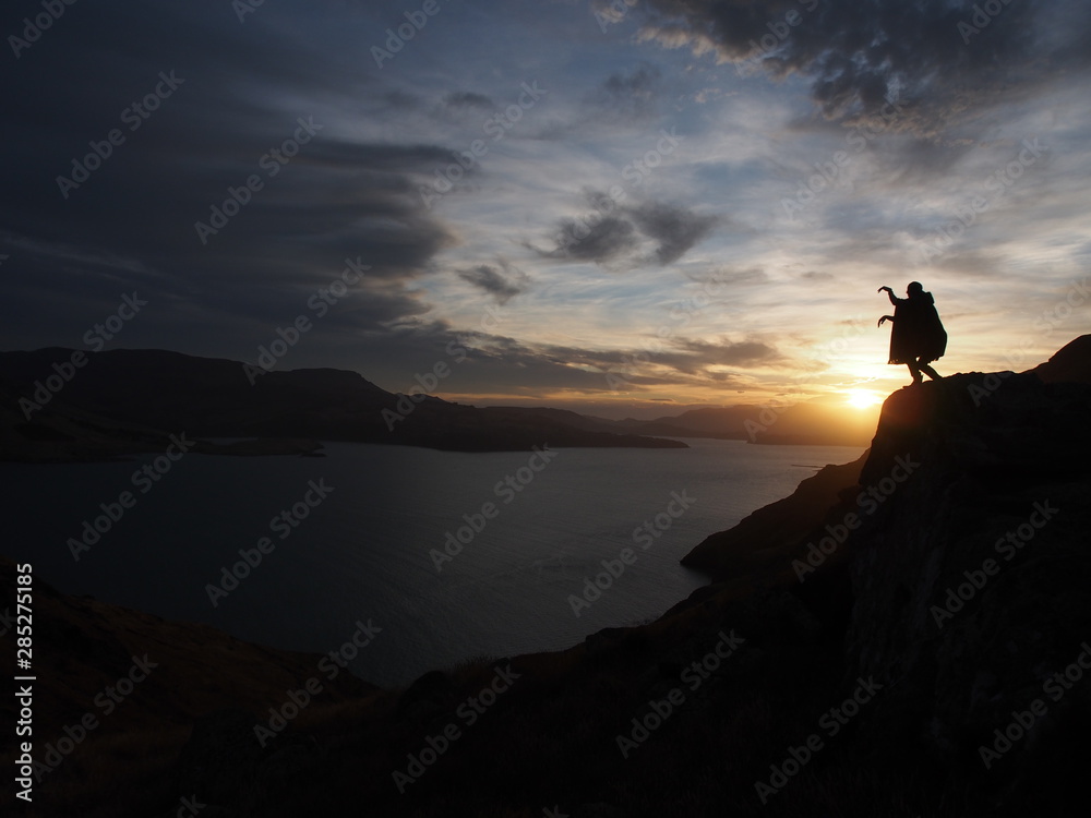 silhouette of a man on top of the mountain