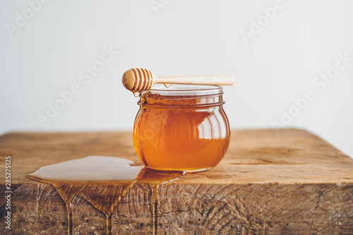 Honey in a glass and Honey scoop White background
