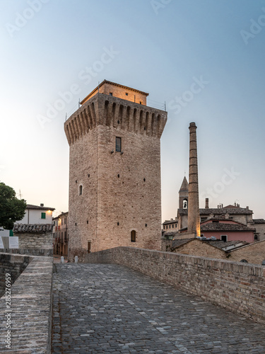 The tower of Fermignano (Pesaro-Urbino province) as seen from the roman bridge over the Metauro river after the sunset photo