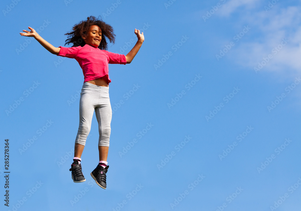 Little beautiful girl jump high over blue sky Little beautiful girl jump high over blue sky