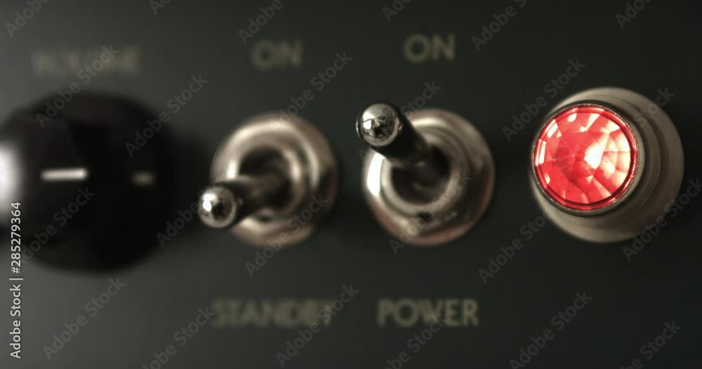 Guitarist Powering On Vintage Tube Guitar Amplifier. Music Related 4K Concept