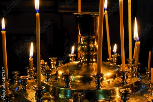 Thin funeral candles burn © aviavlad