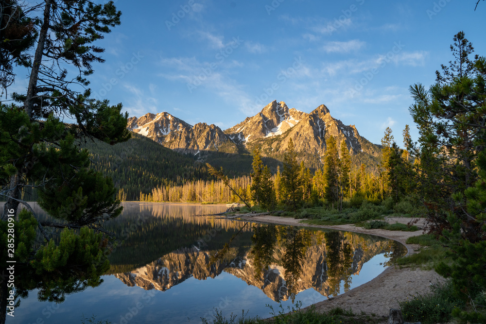 Sunrise at Stanley Lake in Idaho. Calm water with mountain reflection