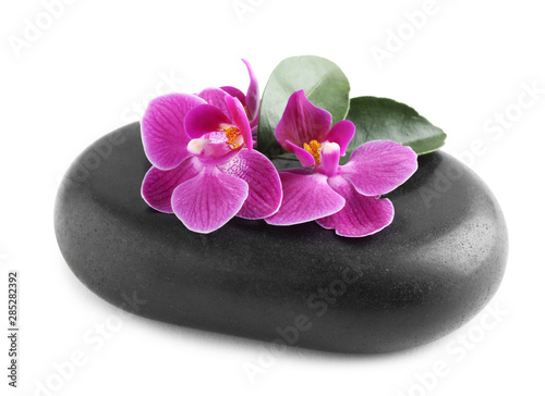 Spa stone and orchid flowers on white background