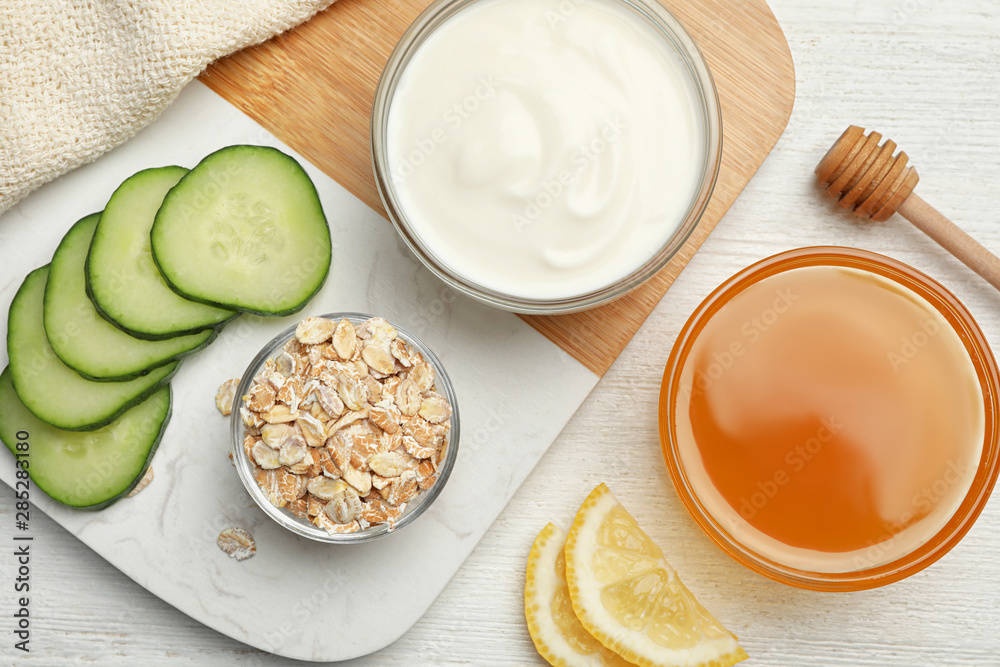 Different ingredients for handmade face mask on table, flat lay