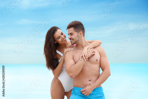 Happy young couple spending time together on beach © New Africa