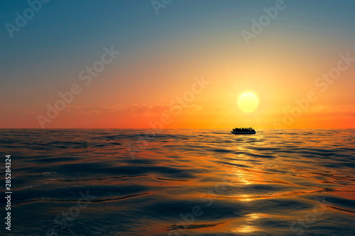 Fotografie Refugees on a big rubber boat in the middle of the sea that require help