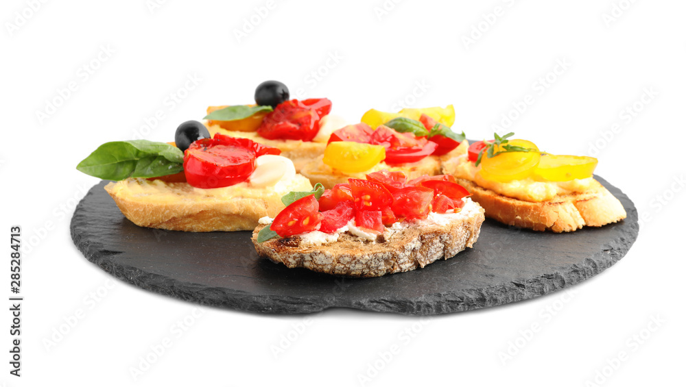 Slate plate of delicious tomato bruschettas on white background