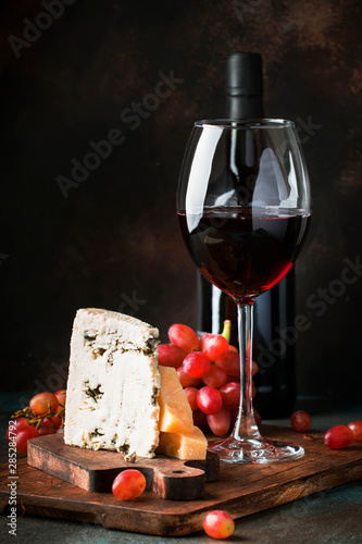 Fototapeta Naklejka Na Ścianę i Meble -  Port wine and blue cheese, still life in rustic style, vintage wooden table background, selective focus