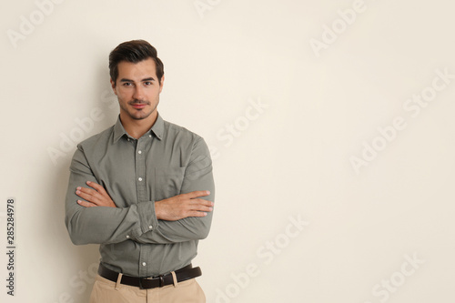 Young male teacher on beige background. Space for text © New Africa