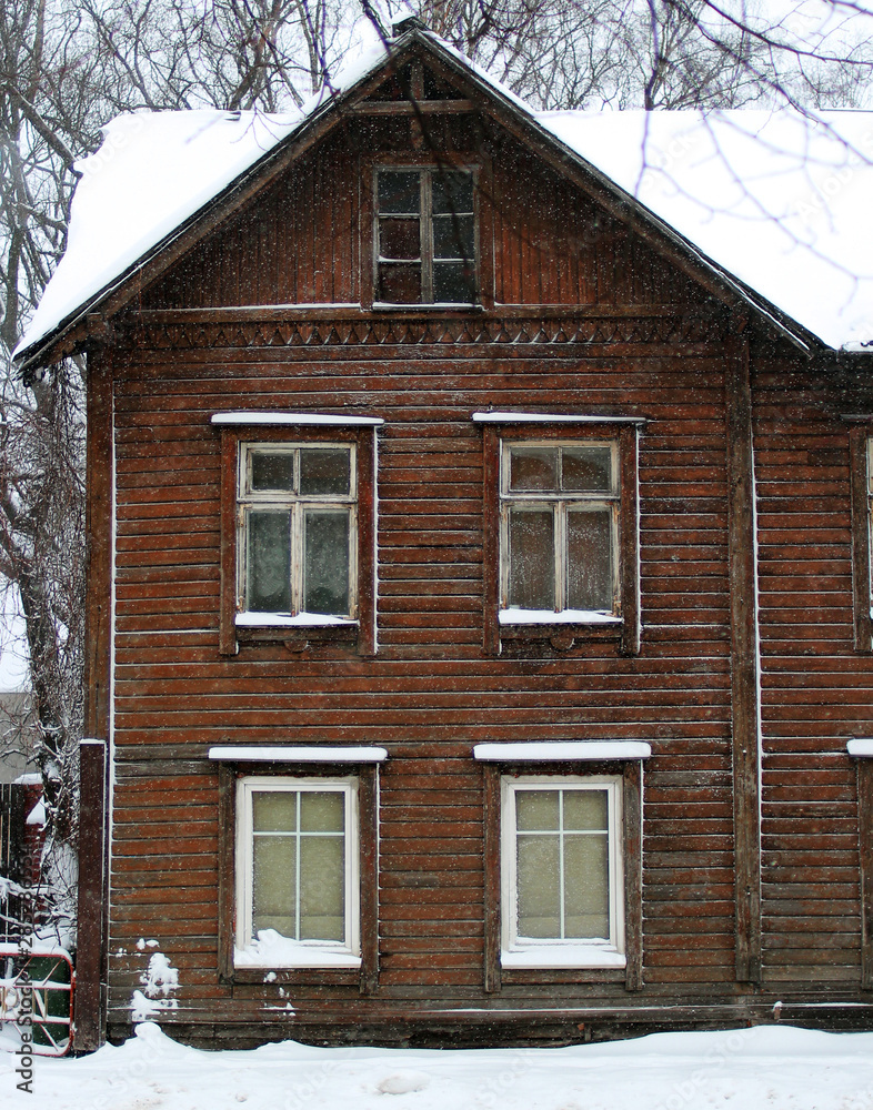 old wooden house in snowy town 