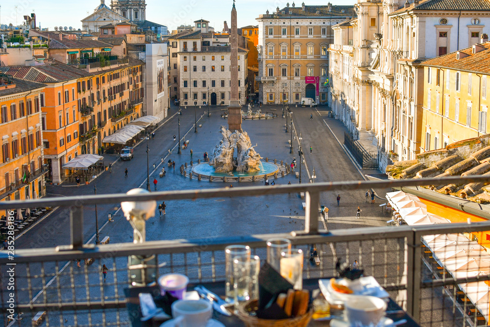 Continental breakfast on a roof top bar overlooking the Piazza Navona on an early summer morning.