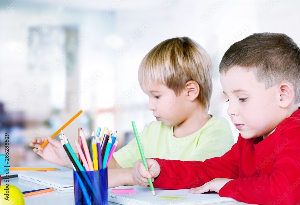 Two little boys studying subject on background Two little boys studying subject on background