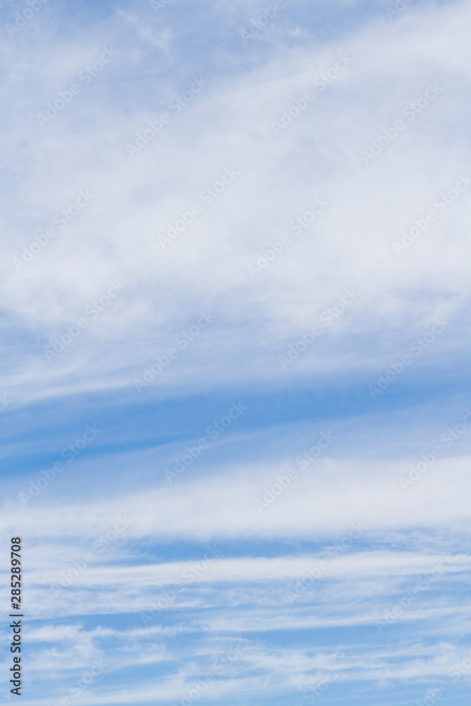 White fluffy clouds in the blue sky in summer White fluffy clouds in the blue sky in summer