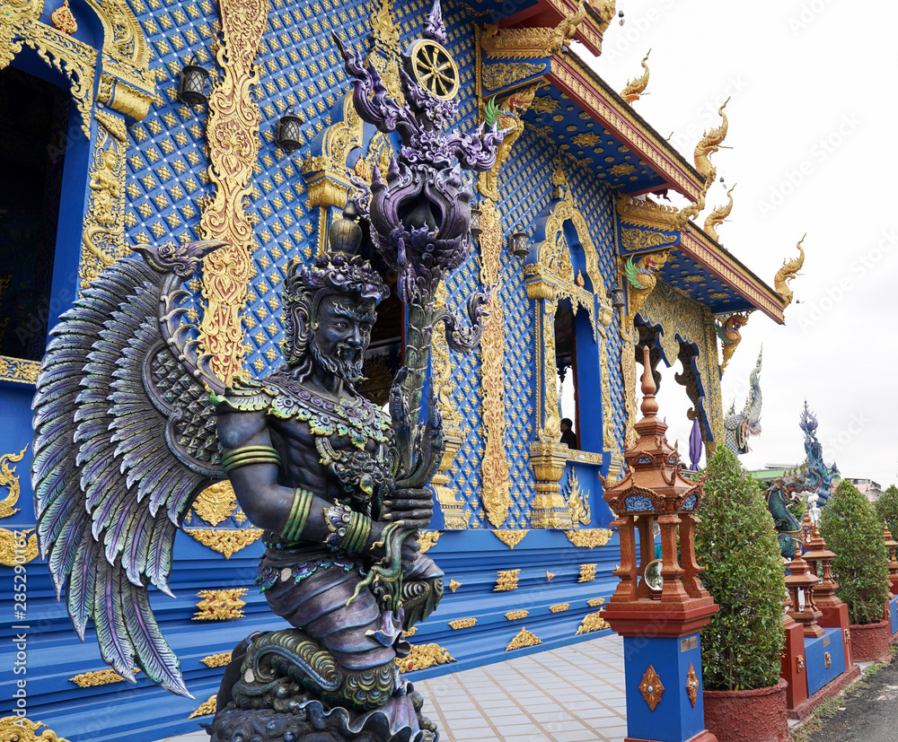 Fototapeta premium The Blue - Turquiose metalic God statue in Thai blue temple, at the North of Thailand.