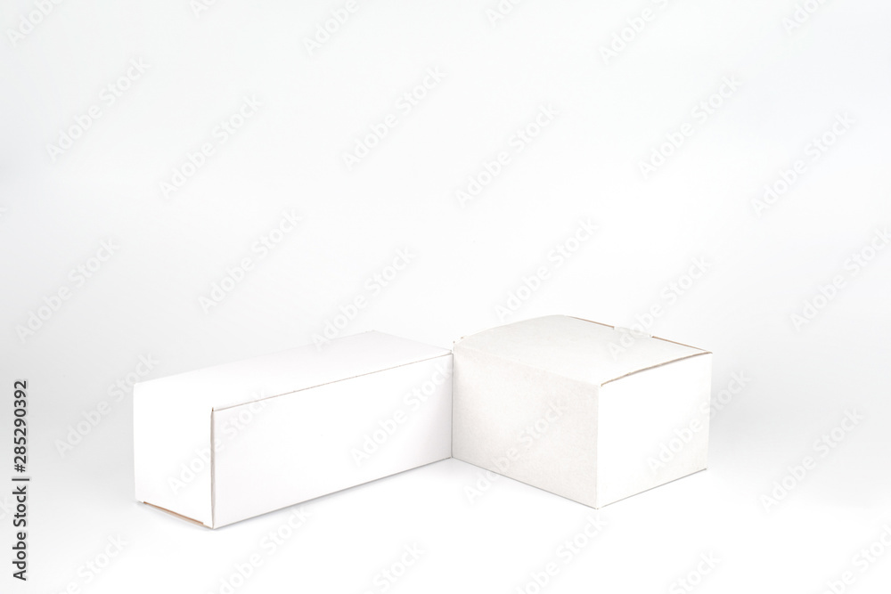 White two paper boxes - tall and fat lay on the white background in studio shot with clipping paht. White two paper boxes - tall and fat lay on the white background in studio shot with clipping paht.