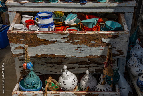 Greek souvenirs from the island of Santorini in the Aegean Sea. Lamps, ceramic jars in the traditional Greek style. Exposed in an old trumeau in the city of Oia on the island of Santorini, Greece. photo