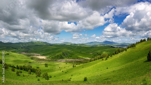 panorama of mountains with a forest in the Altai region in the last rays of the sun, Russia