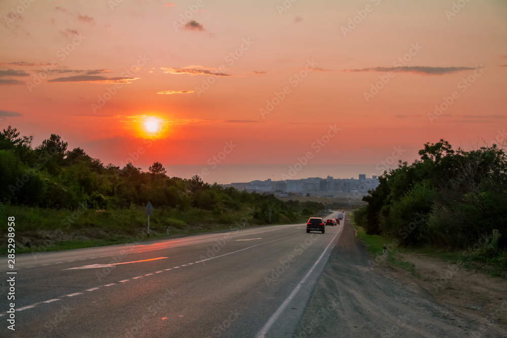 The road to the city against the setting sun.