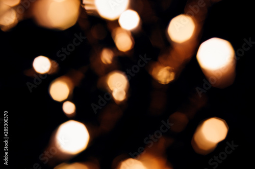 Golden abstract bokeh sparkle on black isolated background. Holiday concept. Place for design. Festive concept.