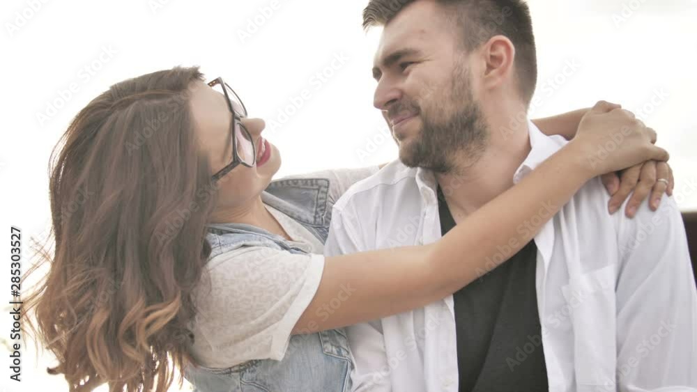 Couple of friends having good time in the city. The girl hugs her friend after a long time they don't see each other Couple of friends having good time in the city. The girl hugs her friend after a long time they don't see each other