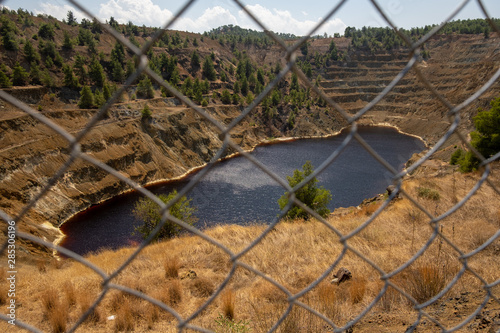 The red lake at mitsero behind the fence photo