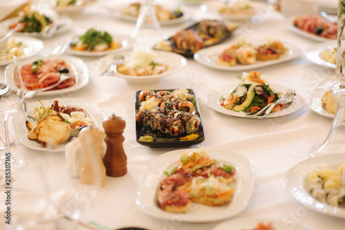 Table with mixed food. Banquet in restaurant, table setting. Differend meals for the guests. Fresh food