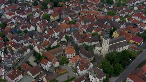 Aerial view from the old part of the city Lauda-Königshofen in Germany.  Low angle shot. Camera rotates left around the baroque Church of St. Jakobus. photo