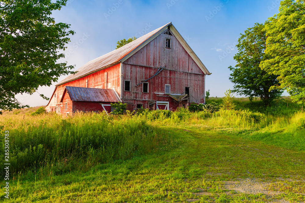 Weathered old red barn in a rural setting. Weathered old red barn in a rural setting.