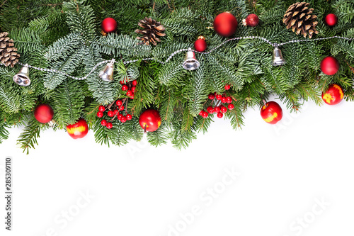 Christmas decorative background border with red bauble decorations  holly berries  spruce and pine cones