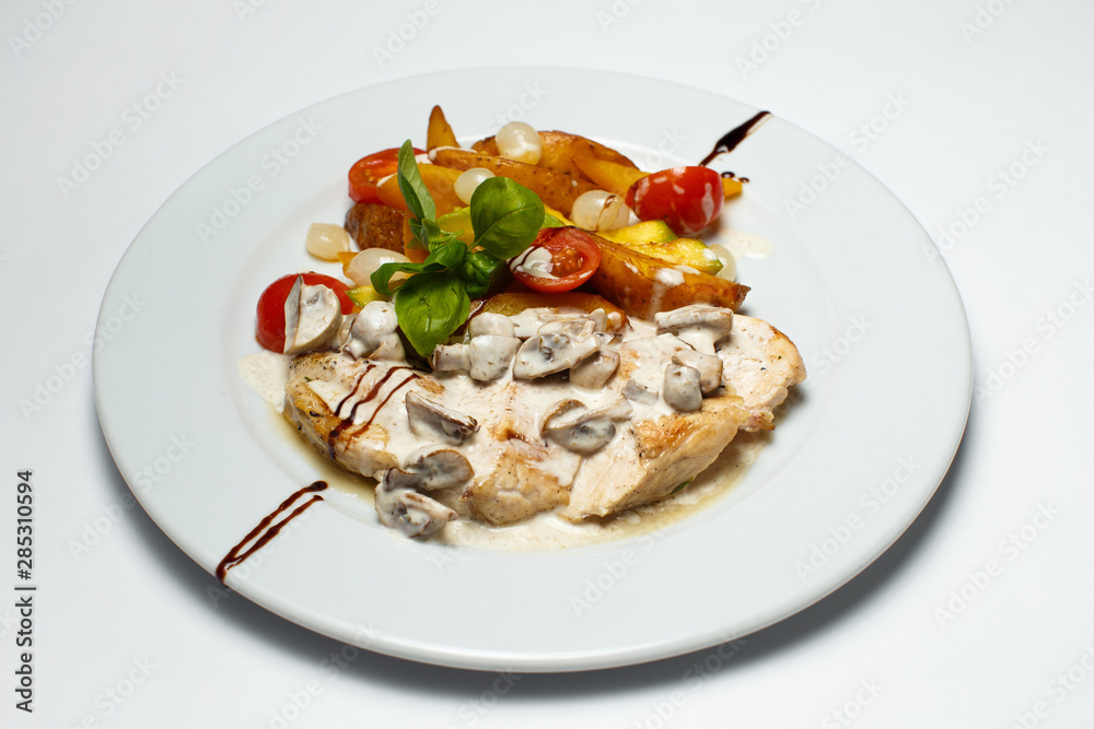 chicken breast in cream sauce with mushrooms and grilled vegetables